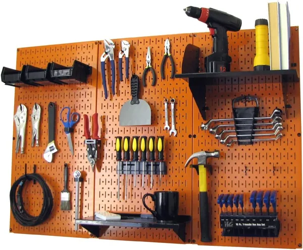 Garage pegboard wall system holding hand tools and workshop accessories