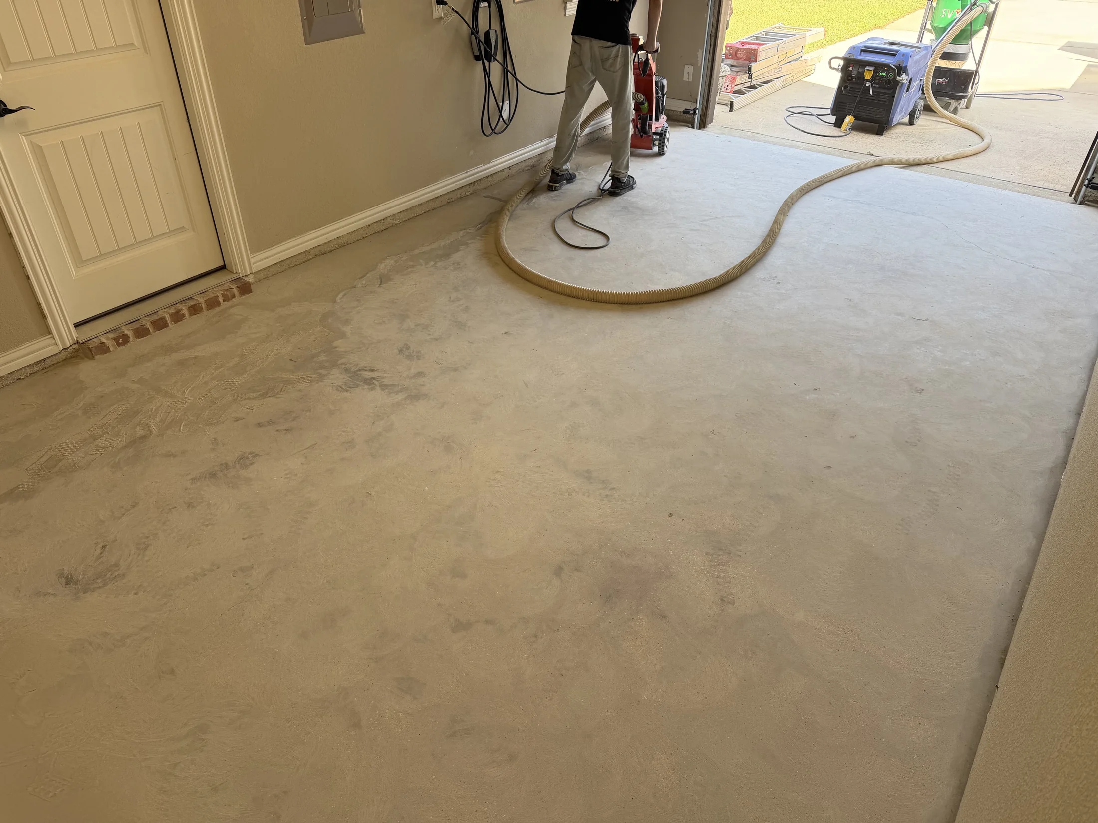 Concrete grinding and prep during garage floor coating installation in Colleyville, Texas