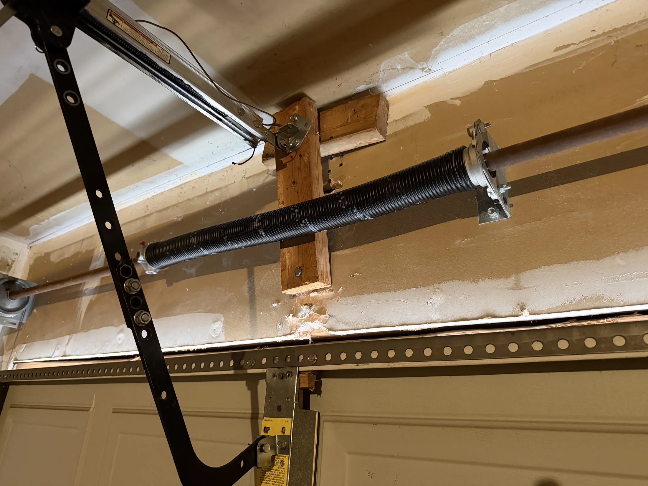 New torsion spring installed above a garage door in Fort Worth, Texas