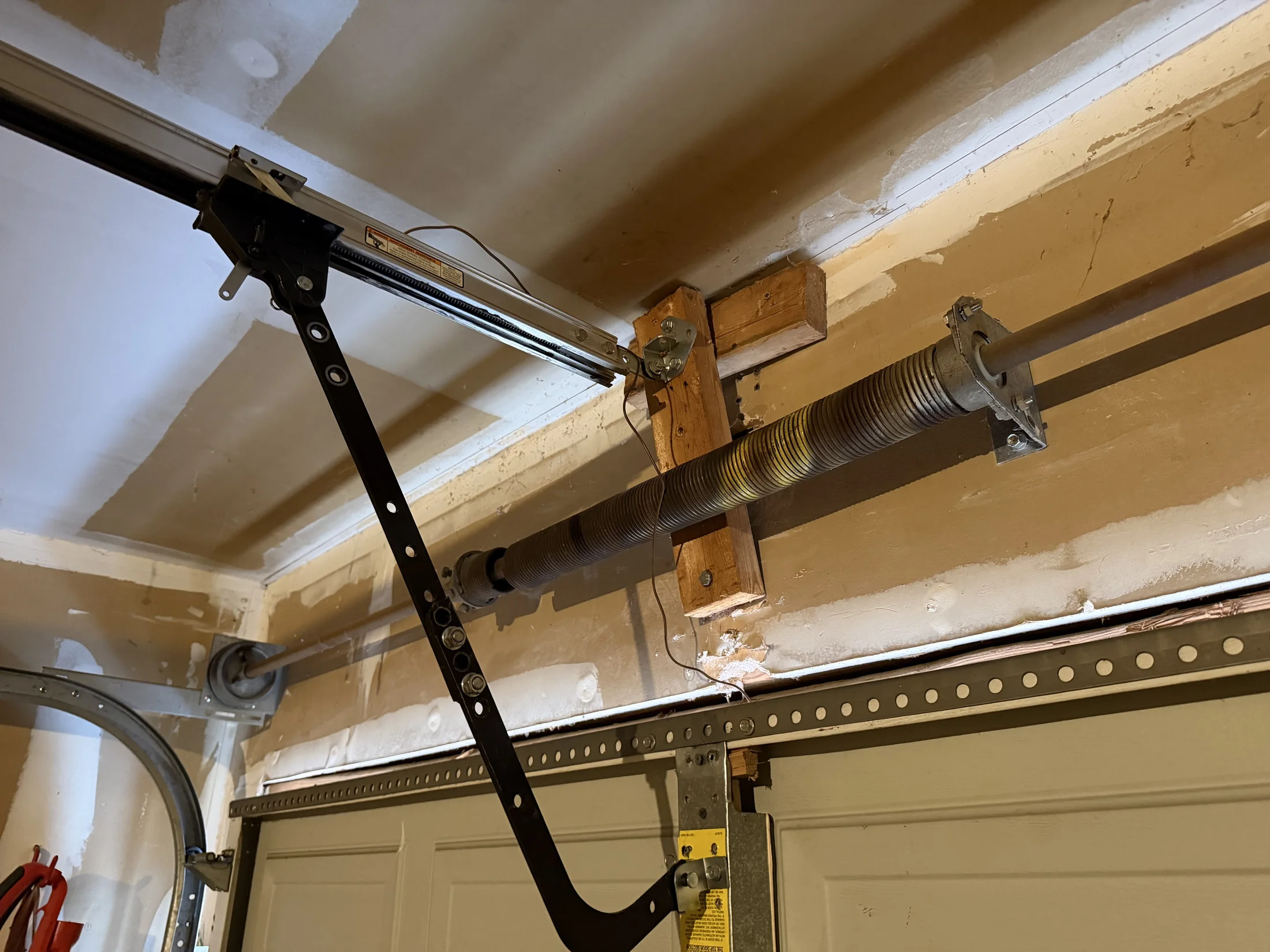 Broken torsion spring setup above a garage door in Fort Worth, Texas