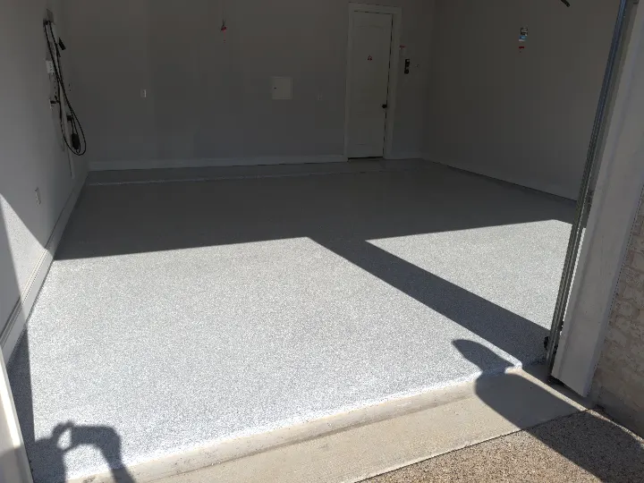 Schist full-broadcast flake garage floor coating installed in a Roanoke Texas two-car garage.